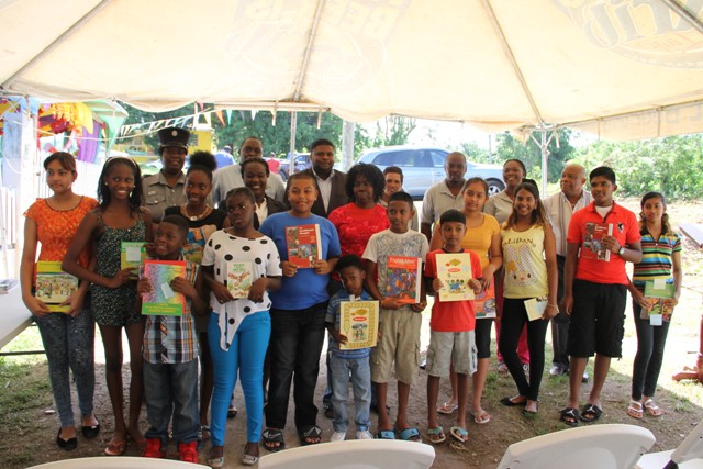Recipients of the Cane Garden Community Improvement Club Incorporated Text Book Initiative Drive on August 15, 2016, with (back row l-r) Police Officer Shawna Pemberton, Managing Director at LEFCO Equipment Rental and Construction Company Ltd. Robelto Liburd, Junior Minister in the Nevis Island Administration Hon. Troy Liburd, Public Relations Officer Gweneth Browne, President of the Cane Garden Community Improvement Club Incorporated Randy Elliott, Vice President, Petronella Hinds and former Area Representative Hensley Daniel